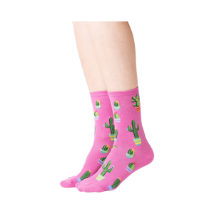 Lifestyle shot showing a model wearing the pink Potted Cactus socks.