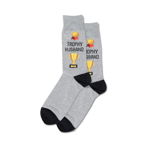 Pair of crew socks; grey and navy options; feature gold trophy and 'Trophy Husband' text.