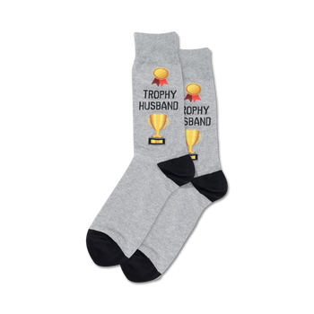 gray crew socks with black toes and heels. "trophy" and "husband" in red and yellow letters. gold trophies in the middle of each word.   