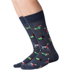 Close-up of a person's legs wearing dark gray Christmas dog socks against a black background.