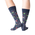 Back view of a person's legs wearing dark gray Christmas dog socks against a black background.