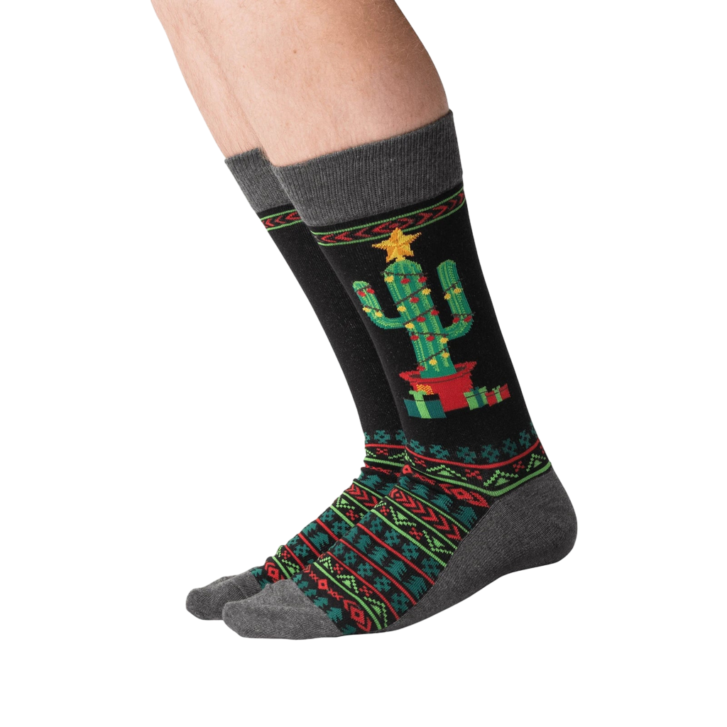 Lifestyle shot of a person wearing the Christmas Cactus Non-Skid Slipper socks.