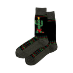 Pair of Christmas Cactus Non-Skid Slipper socks. Black with a decorated cactus image, geometric patterns, and grey cuffs.