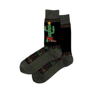 Pair of Christmas Cactus Non-Skid Slipper socks. Black with a decorated cactus image, geometric patterns, and grey cuffs.