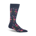 Crew socks in navy blue featuring pink flamingos wearing Santa hats and holding sprigs of holly. Snowflake accents complete the design.