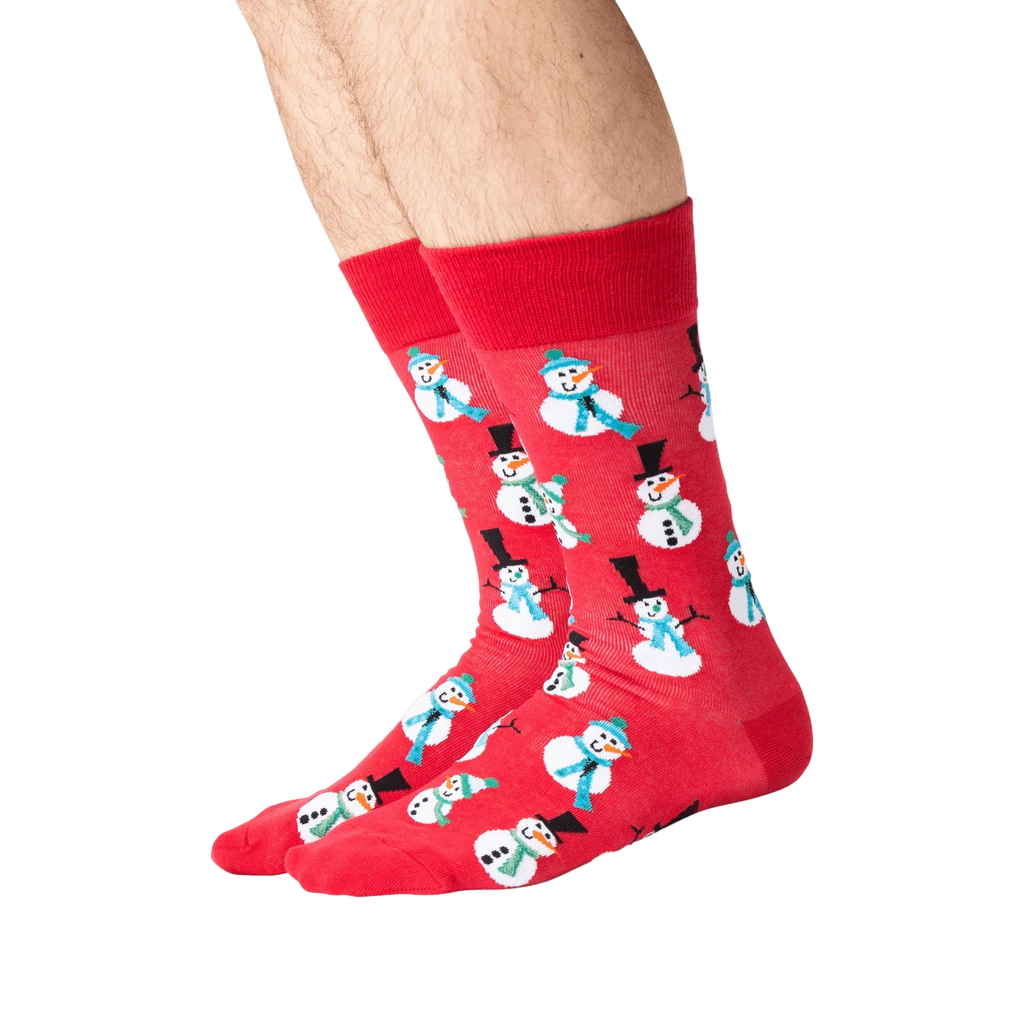 Lifestyle shot of a person's legs wearing red snowman socks.