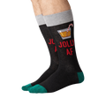 Flat lay of a pair of 'Jolly AF' socks. They are black with green cuffs.