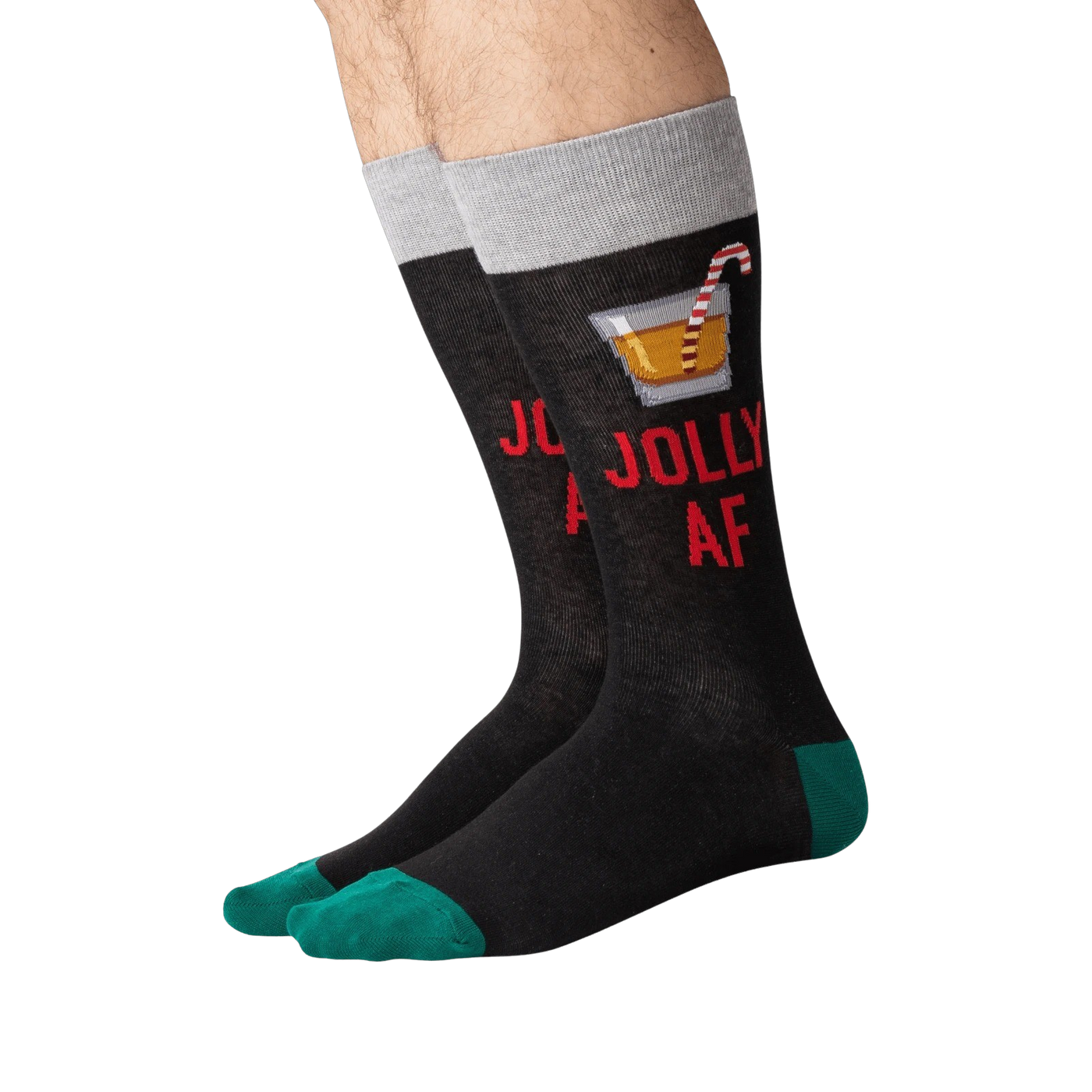 Flat lay of a pair of 'Jolly AF' socks. They are black with green cuffs.
