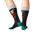 Back view of a person wearing black 'Jolly AF' socks; shows off the full design on the back of the socks.