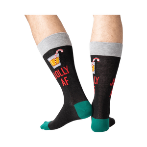 Back view of a person wearing black 'Jolly AF' socks; shows off the full design on the back of the socks.
