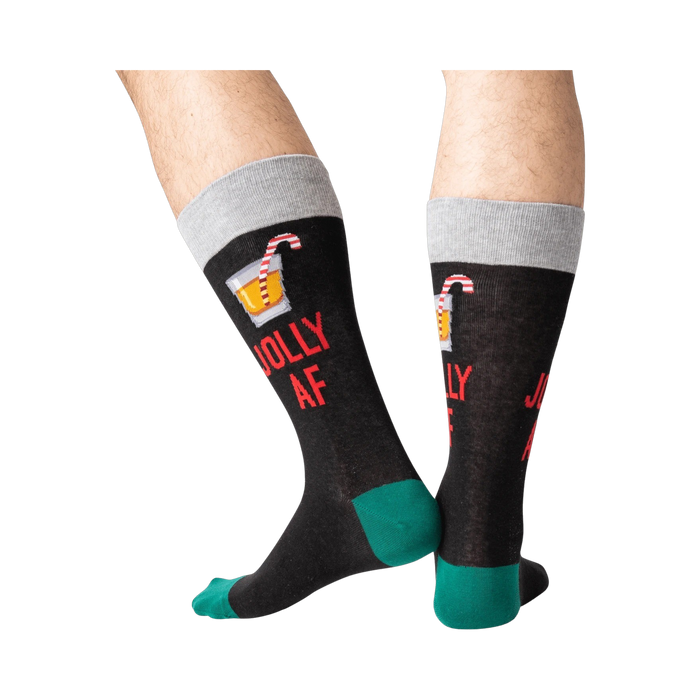 Back view of a person wearing black 'Jolly AF' socks; shows off the full design on the back of the socks.
