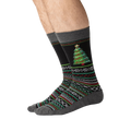 Lifestyle shot showing the Christmas tree slipper socks on a person's feet.