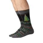 Lifestyle shot showing the Christmas tree slipper socks on a person's feet.