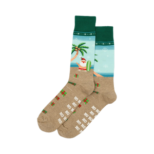 Pair of crew socks. Tan base with a light blue beach scene, surfing Santa, palm tree, presents, and 'Ho Ho Ho' print. Red and green cuffs.