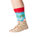 Lifestyle shot of a person's legs wearing the Surfing Santa socks.