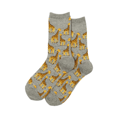 Pair of grey crew socks with a repeating pattern of yellow and brown giraffes of varying sizes.