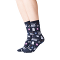Lifestyle shot of woman's legs wearing dark gray Accountant socks. The socks are visible from the ankles down.