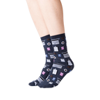 Lifestyle shot of woman's legs wearing dark gray Accountant socks. The socks are visible from the ankles down.