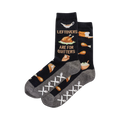 Crew socks in navy blue feature a Thanksgiving-themed pattern including turkey, pie, and bread.  The saying 'Leftovers Are For Quitters' is shown.