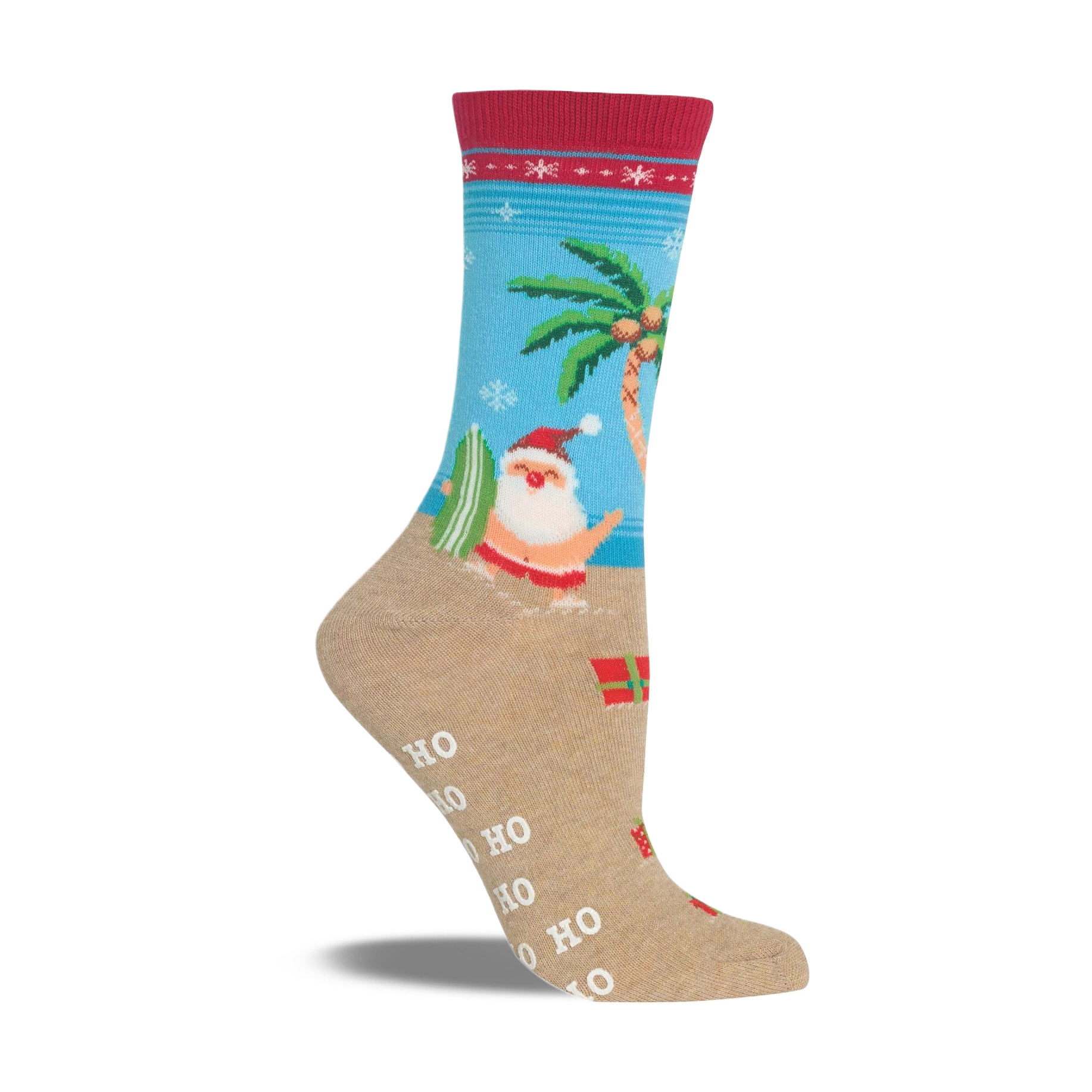 Beige non-skid slipper sock with a red cuff. Features Santa surfing, a palm tree, snowflakes, and presents on a beach scene.