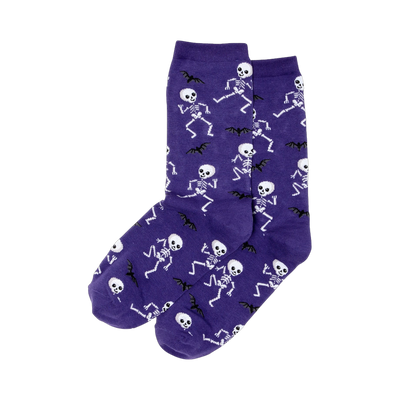 Pair of purple crew socks featuring a pattern of white dancing skeletons and black bats.