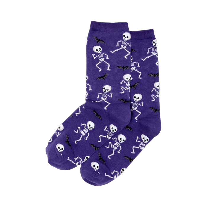 Pair of purple crew socks featuring a pattern of white dancing skeletons and black bats. }}