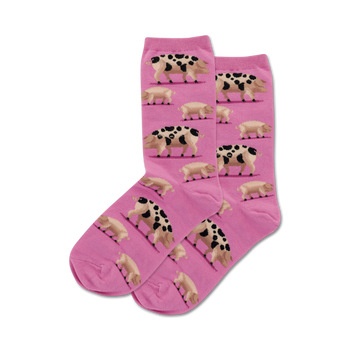 novelty crew socks for women featuring a pattern of pink, brown and black spotted pigs.   