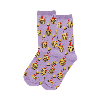 Pair of crew socks with a soft lavender background, patterned with yellow pineapple drinks, red straws, cherries, and pineapple slices.