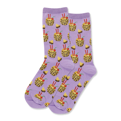 Pair of crew socks with a soft lavender background, patterned with yellow pineapple drinks, red straws, cherries, and pineapple slices.