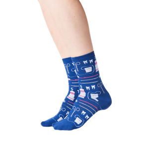 A pair of blue socks with a pattern of dental instruments and teeth.