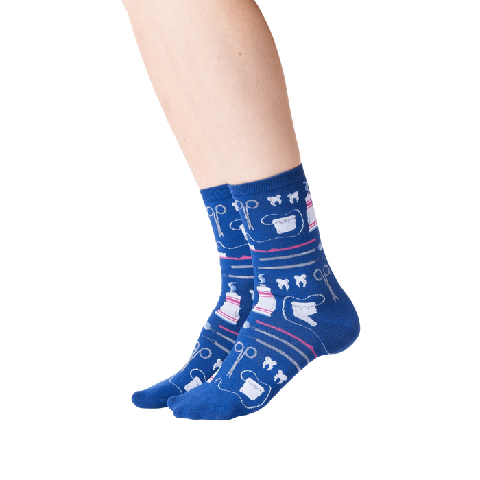 A pair of blue socks with a pattern of dental instruments and teeth.