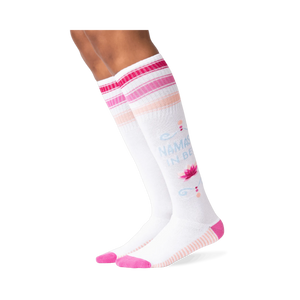 Lifestyle photo of model wearing 'Namaste In Bed' knee-high socks.