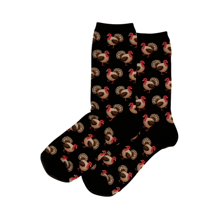 Pair of black crew socks with a repeating pattern of brown and red turkeys. 