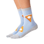 Pair of light blue crew slipper socks with gray heel, toe, and cuff, featuring pie slices with whipped cream, worn on feet.