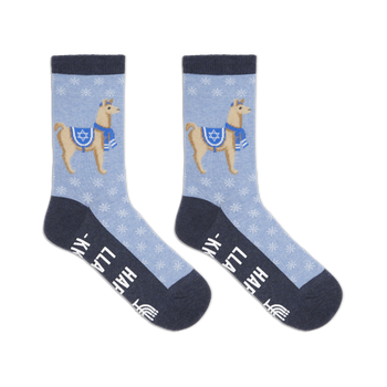 Crew socks in light blue with a snowflake pattern.  Each sock features a tan llama wearing a blue scarf and a Star of David. The text 'Happy Llamakkah' is visible on the sole.