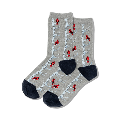 women's crew socks featuring red cardinals on snowy birch trees, perfect for the christmas season. dark blue toes and heels.   