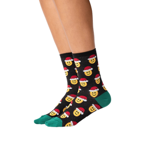 Lifestyle shot of a person wearing the Santa Smile Emoji socks. Shows how the socks look on the feet.