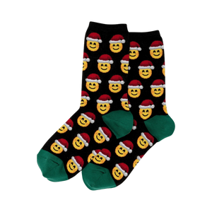 Pair of black crew socks.  Feature a repeating pattern of yellow smiley faces wearing red Santa hats. Green cuffs.