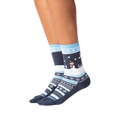 Lifestyle shot showing the socks on a person's legs against a black background.