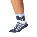 Lifestyle shot showing the socks on a person's legs against a black background.