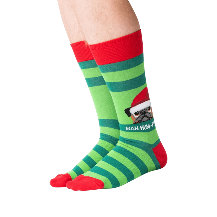 Lifestyle shot showing the socks on a person's feet.  The socks are green and red striped with a pug graphic.