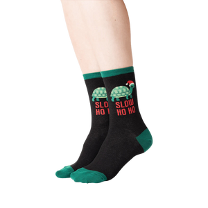 Lifestyle shot of a person wearing the 'Slow Ho Ho' socks, showcasing the fit and design.
