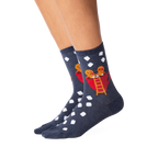 Lifestyle shot showing the Gingerbread Couple socks on a person's legs.  The socks' design is clearly visible.