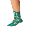 Lifestyle shot of a person's legs wearing the teal gingerbread house socks.