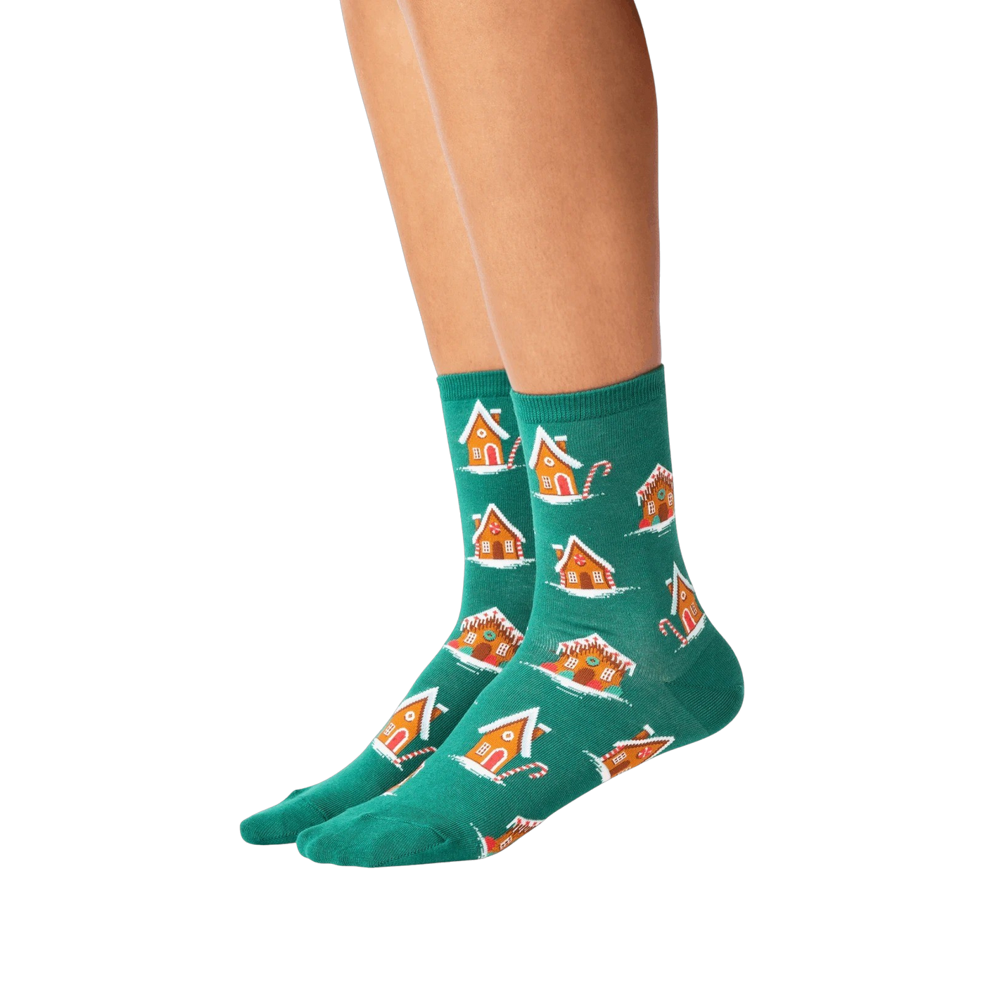 Lifestyle shot of a person's legs wearing the teal gingerbread house socks.