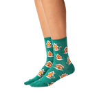 Lifestyle shot of a person's legs wearing the teal gingerbread house socks.