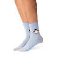 Lifestyle shot showing the penguin socks on a person's legs. The socks are mostly blue and grey, with a subtle striped pattern. A small, embroidered penguin is visible near the ankle area. A good example of how the socks look when worn.