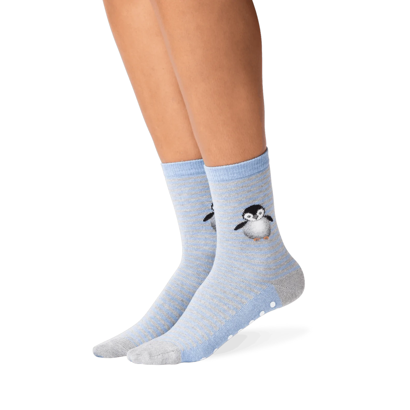 Lifestyle shot showing the penguin socks on a person's legs. The socks are mostly blue and grey, with a subtle striped pattern. A small, embroidered penguin is visible near the ankle area. A good example of how the socks look when worn.
