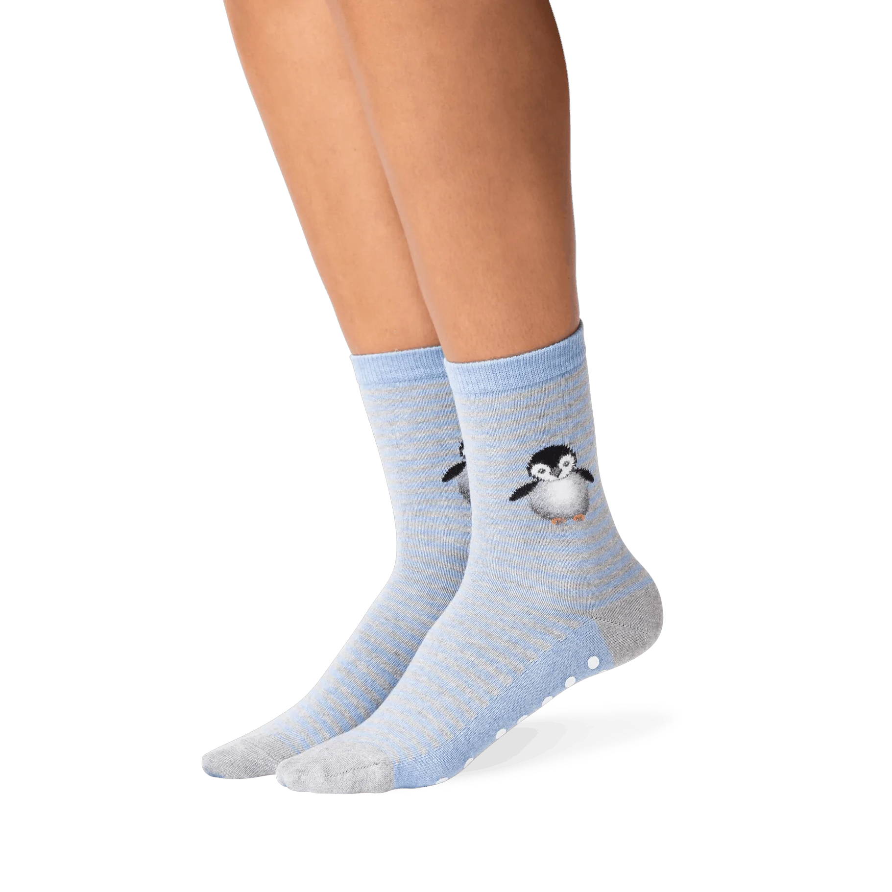 Lifestyle shot showing the penguin socks on a person's legs. The socks are mostly blue and grey, with a subtle striped pattern. A small, embroidered penguin is visible near the ankle area. A good example of how the socks look when worn.