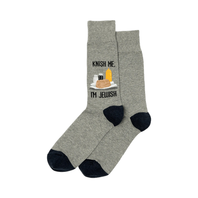 A pair of heather gray crew socks with a navy blue cuff. The socks show a graphic of a knish, mustard, and seasonings with the text 'Knish Me, I'm Jewish'.
